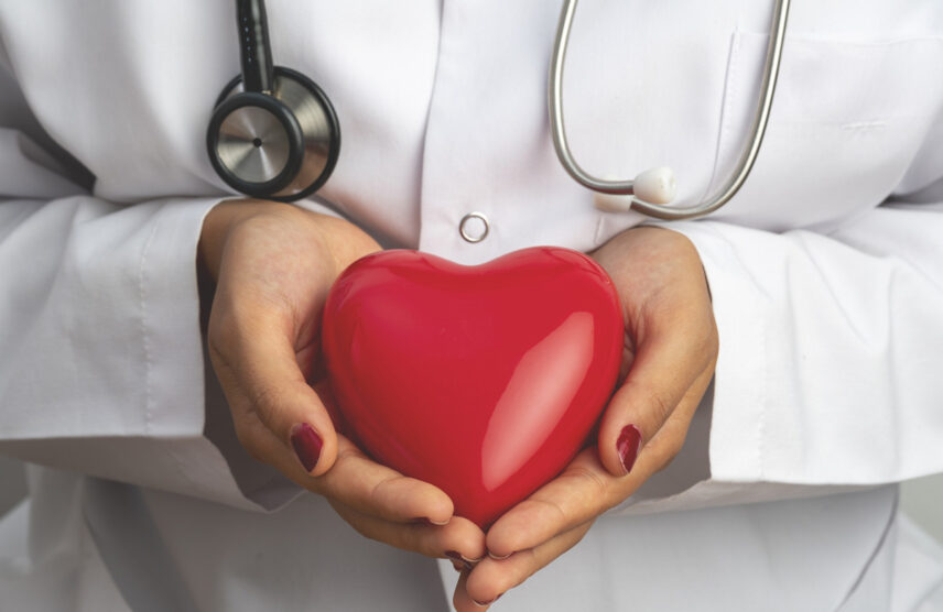 Medical doctor holding an image of a heart