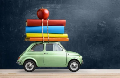 Should you take a car to college? Karine Volkswagen with books and a red apple tied to the top.