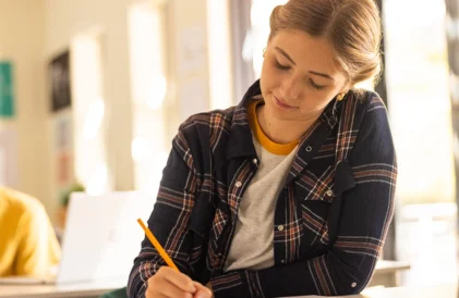 The ultimate seen your to do list for college prep. High school senior female working on a document.