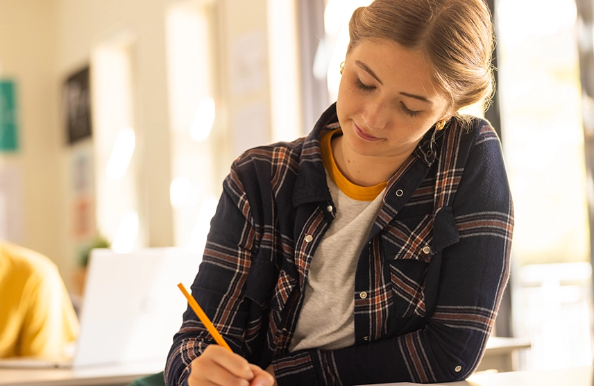 The ultimate seen your to do list for college prep. High school senior female working on a document.